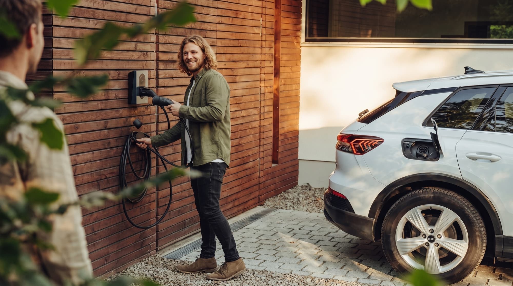 A person charging their electric car at a private home wallbox